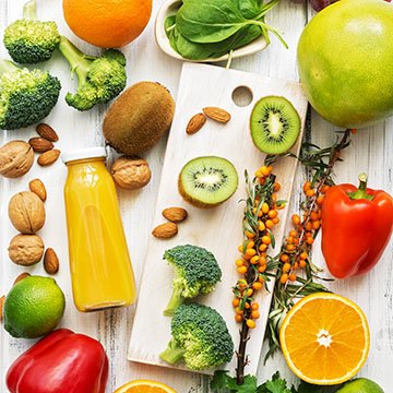 Foods high in vitamin C. Fruits, vegetables, nuts, greens, citrus fruits. Top view, flat lay. The concept of healthy nutrition and vitamins